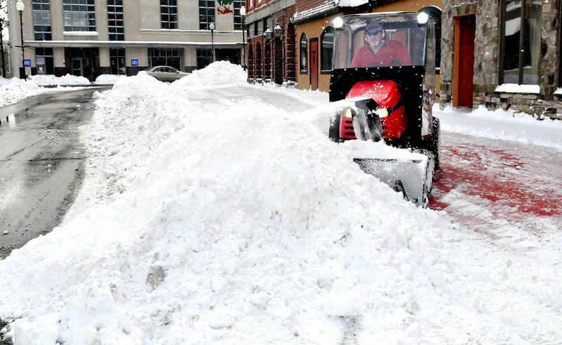 Central Maine residents woke up to nearly a foot of snow on Wednesday, on the first day of spring. Bruce Heath of KB Property Care clears the outdoor dining area on Silver Street in downtown Waterville.