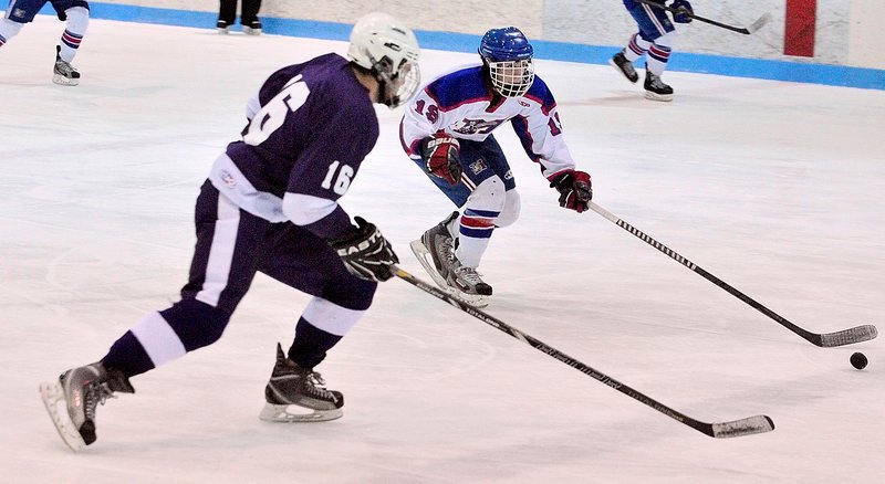 William Manning, left, of Hampden Academy chases Messalonskee’s Jared Cunningham during their Eastern Class B boys’ hockey semifinal Saturday at Sukee Arena.