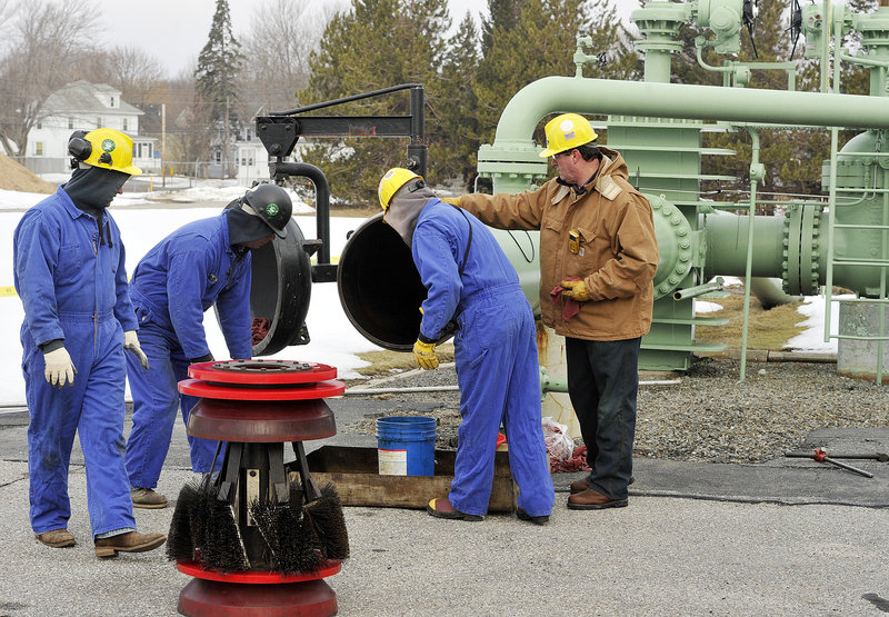 Pipeline workers prepare the scraper-launching trap in mid-March before their brush “pig” device was to begin its two-and-a-half-day trip to Montreal to clean the 24-inch-diameter pipe.