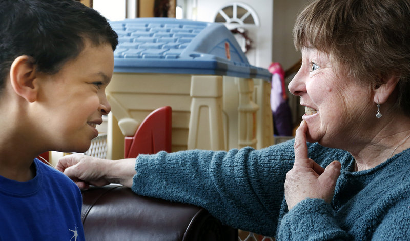 Shavar smiles as his nurse, Darlene Hayden, shows him her teeth after she returned from the dentist.