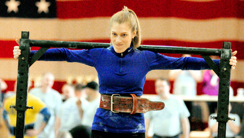 Annie Philbrick, of Sidney, carries a weighted yoke in the yoke walk event during the 2013 Central Maine Strongman contest on Saturday at the Augusta armory.