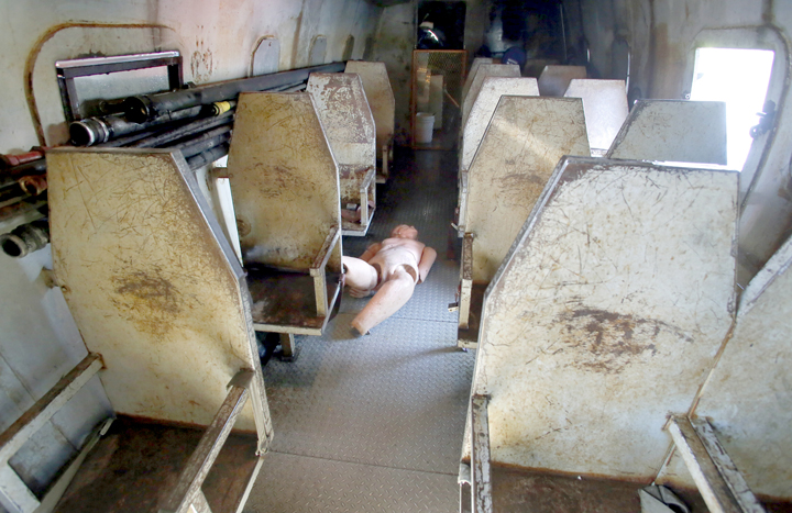 A mannequin lies in the aisle of the Aircraft Rescue Fire Trainer during the annual FAA training exercise at the Portland International Jetport in Portland on Tuesday.