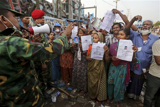 Bangladeshi relatives of missing workers in a building that collapsed on Wednesday argue with army officials Sunday at the search operation in Savar, near Dhaka, Bangladesh.