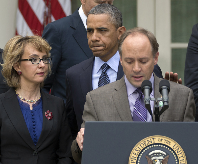 President Obama arrives to participate in a news conference about measures to reduce gun violence, in the Rose Garden of the White House on Wednesday. With Obama are former Rep. Gabby Giffords, left, and Mark Barden, the father of Newtown shooting victim Daniel.