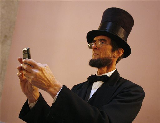 Robert Broski, a member of the Association of Lincoln Presenters, takes a photo with his cellphone during a visit to the Ohio Statehouse in Columus on Friday.