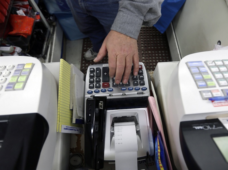 In this Monday, Feb. 25, 2013 file photo, Jack Yonally rings out a customer at Lodge's store in Albany, N.Y. The Commerce Department issues its first estimate of how fast the U.S. economy grew in the January-March quarter on Friday, April 26, 2013.