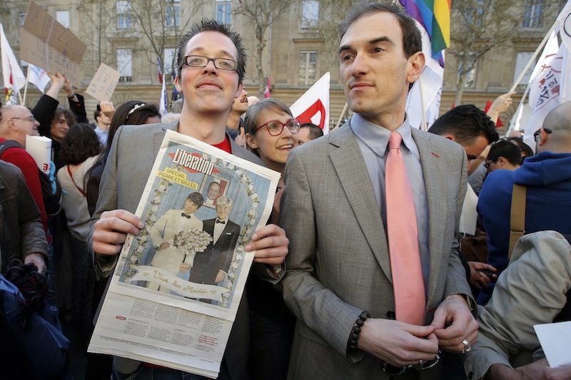 Pro gay marriage activists pose after French lawmakers legalized same-sex marriage, Tuesday, April 23, 2013 in Paris. Lawmakers legalized same-sex marriage after months of bruising debate and street protests that brought hundreds of thousands to Paris. Tuesday's 331-225 vote came in the Socialist majority National Assembly. France's justice minister, Christiane Taubira, said the first weddings could be as soon as June. (AP Photo/Francois Mori)