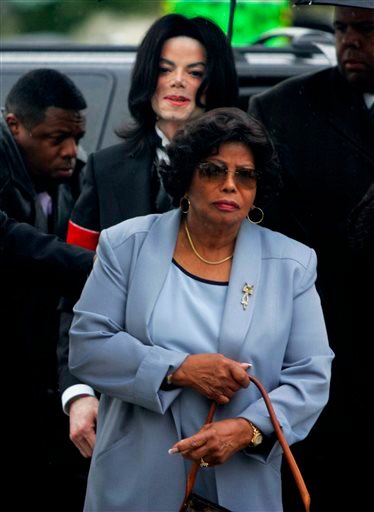In this Feb. 28, 2005, photo, Michael Jackson follows his mother, Katherine Jackson, as they arrive for court on the opening day of his child molestation trial at Santa Barbara County Superior Court in Santa Maria, Calif.