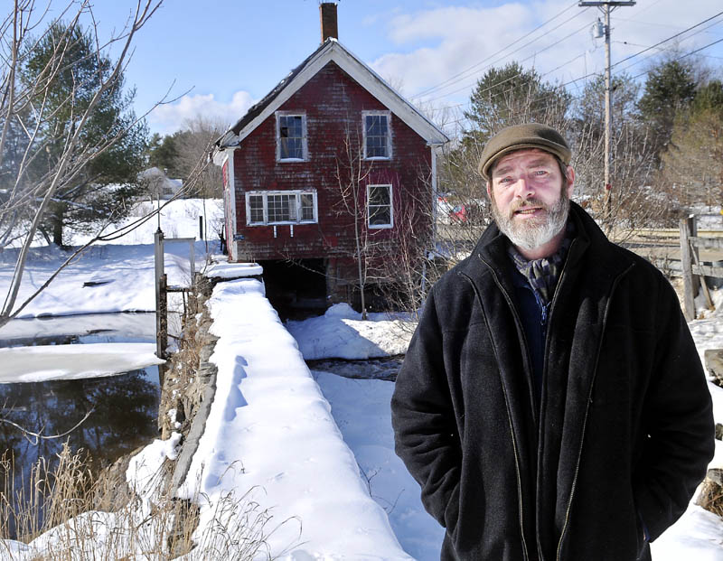 Paul Kelley, the manager of Pleasant Pond Mill LLC, which owns the Clary Lake dam in Whitefield, pictured at the structure on Feb. 26.