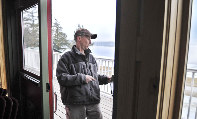 Staff photo by Andy Molloy Pine Tree Camp facility manager Harvey Chesley inspects a door that Christopher Knight alleged broke open in the dining lodge at the Rome camp Tuesday April 9, 2013. Knight, a hermit who lived in the woods since April 1986, was arrested in after breaking into the lodge on April 4, according to Warden Service Sgt. Terry Hughes.