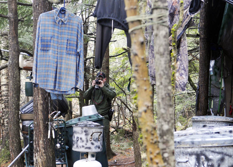 Game Warden Aaron Cross photographs Christopher Knight's camp Tuesday.