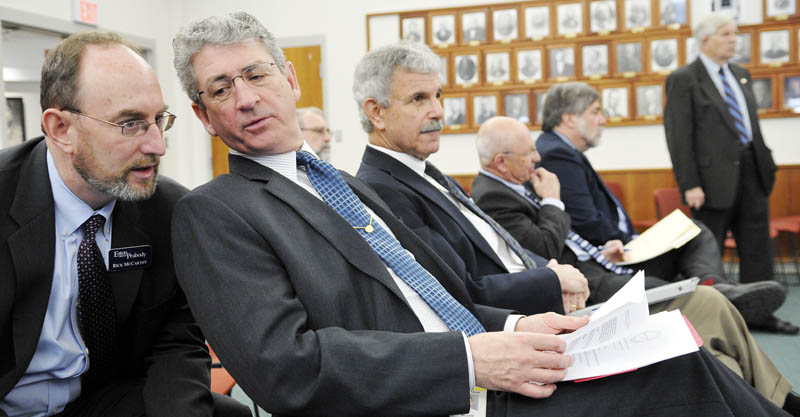 Augusta Mayor Bill Stokes, second from left, confers with Rick McCarthy of Eaton Peabody Consulting Group, during a press conference called by the Mayors' Coalition on Jobs and Economic Development, in Augusta on Monday. McCarthy lobbies for the group. Sen. Roger Katz, R-Augusta and a former Augusta mayor, is sponsoring the $85 million bond package proposal.