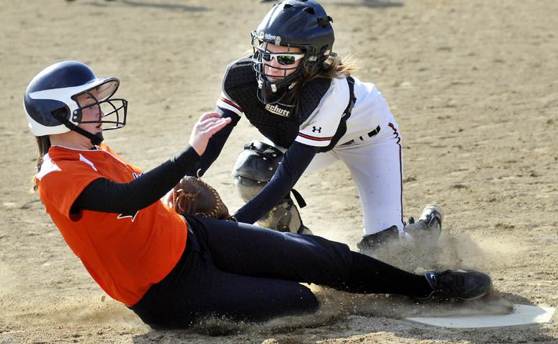 APPLYING THE TAG: Winslow High School catcher Gabby Languet tags Gardiner Area High School's Bri Brochu on Monday in Gardiner.