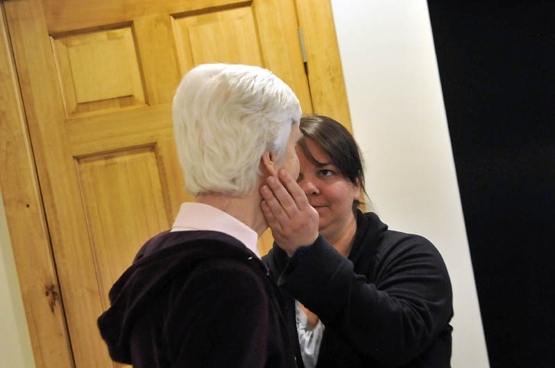 Julie Benecke offers a comforting hand to her mother, Martha Fabian, at Bedside Manor on Belgrade Road in Oakland on Wednesday.