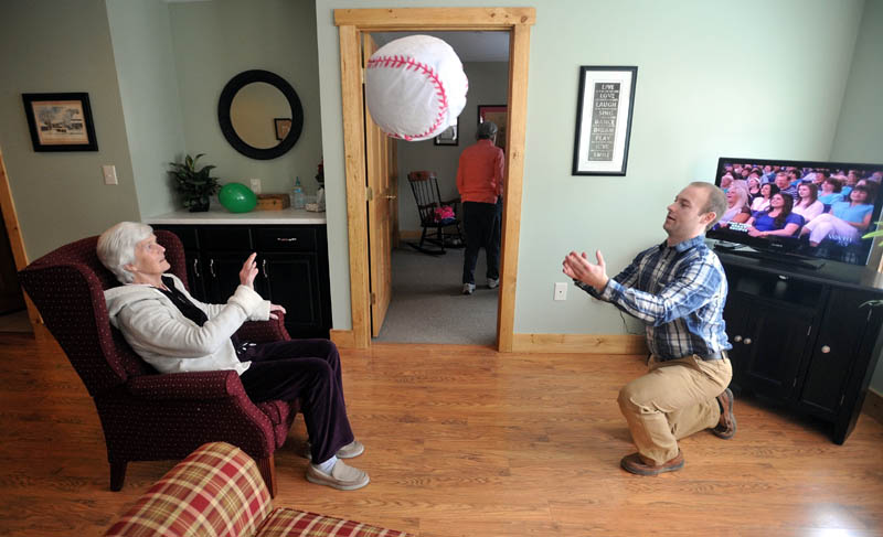 Scott McManaman, right, plays ball with Martha Fabian at Bedside Manor on Belgrade Road in Oakland on Wednesday.