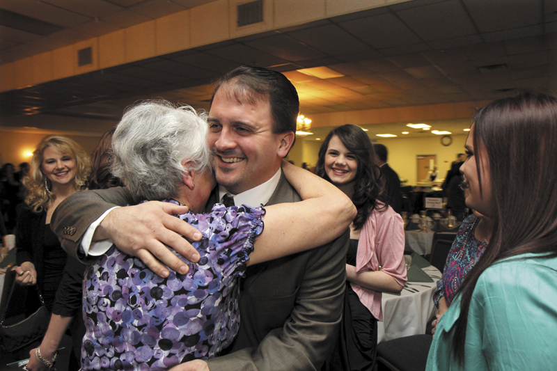 Shawn Michaud of Valley Distributors gets a hug from his mom Eva prior to receiving the Elias A. Joseph Award at the Mid-Maine Chamber of Commerce's annual awards banquet on Thursday night in Waterville. The event was held at the Waterville Elks Banquet & Conference Center.