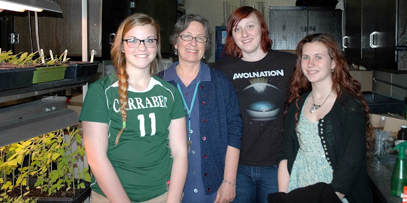 Carrabec High School students Ashlee Knight, Fresca Pray and Molly Gray stand with their environmental studies teacher, Susan Hellewell, second from left, in a classroom on Monday. The environmental studies class, which also includes Leah Poivier, has obtained a grant for the school to purchase reusable water bottles for students and faculty.