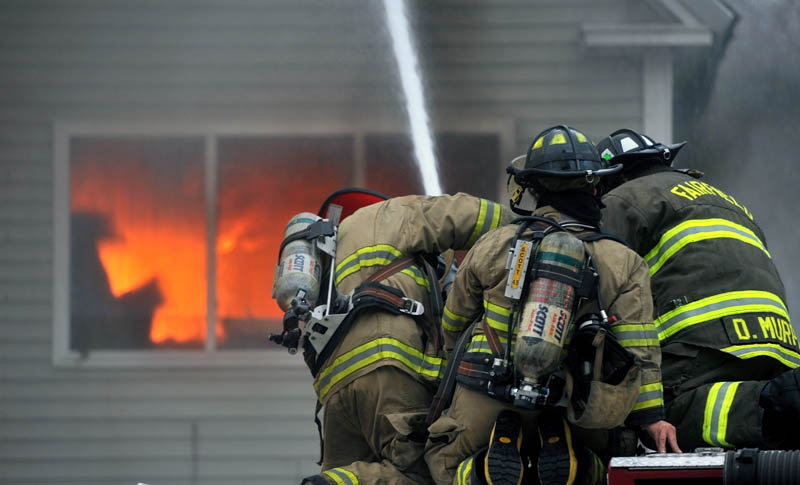 Firefighters from Waterville, Winslow and Fairfield battle a fire at 10 Maple St. in Fairfield on Tuesday.