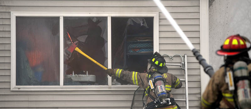 Firefighters from Waterville, Winslow and Fairfield battle a fire at 10 Maple St. in Fairfield on Tuesday.
