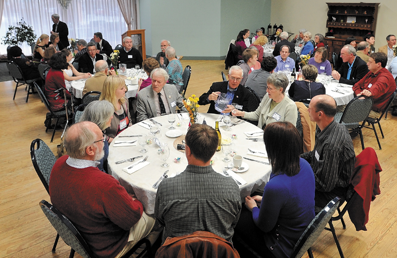 Five social workers from Waterville's sister city, Kotlas, Russia, prepare for a traditional turkey dinner at the Center on Main Street in Waterville on Thursday. The Russian visitors are touring different social services during their one week trip.