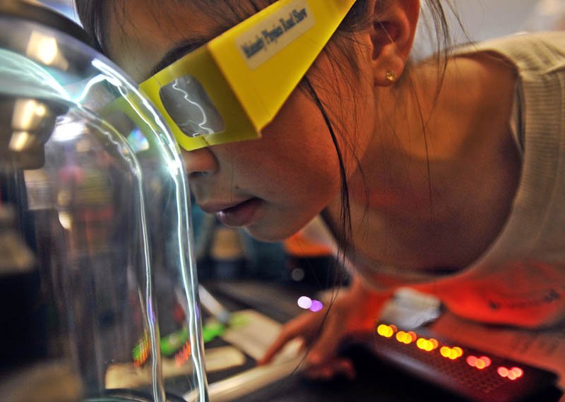 Alexis West, 10, plants her nose on the plasma ball in the first Science, Technology, Engineering and Math Day, at Albert S. Hall School in Waterville on Friday.