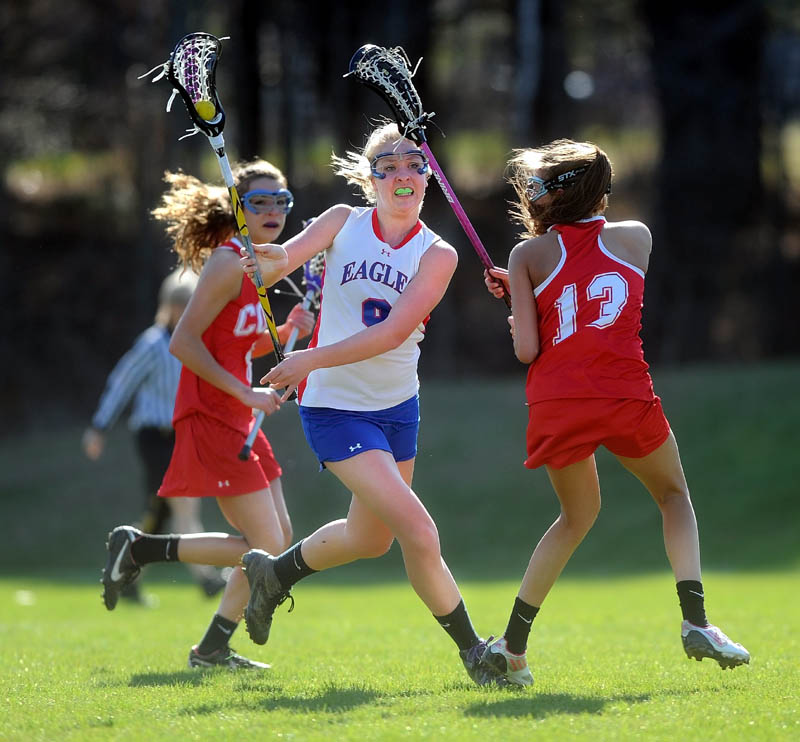 MAKE THE PASS: Messalonskee’s MiKayla Turner, center, looks top pass the ball as Cony’s Hayley Quirion, right, plays defense in the first period of the Eagles’ 10-9 win Thursday at Messalonskee High School in Oakland.