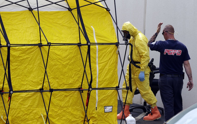 A Prince George's County, Md. firefighter dressed in a protective suit walks out of a government mail screening facility in Hyattsville, Md., Wednesday, April 17, 2013. Police swept across the U.S. Capitol complex to chase a flurry of reports of suspicious packages and envelopes Wednesday after preliminary tests indicated poisonous ricin in two letters sent to President Barack Obama and a Mississippi senator. (AP Photo/Alex Brandon)