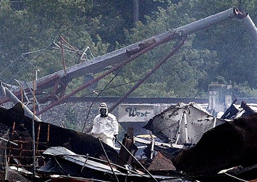 A searcher in a protective suit walks through the blast zone of the fertilizer plant that exploded Wednesday night in West, Texas on Thursday.