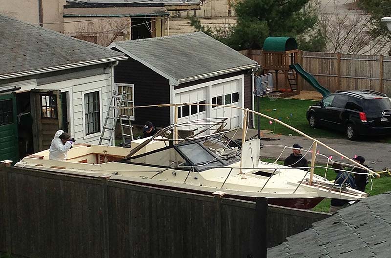 Investigators on Saturday work near the location in Watertown where the previous night a suspect in the Boston Marathon bombings was arrested. Police captured Dzhokhar Tsarnaev, 19, the surviving Boston Marathon bombing suspect, in a backyard boat after a wild car chase and gun battle earlier in the day left his older brother dead.