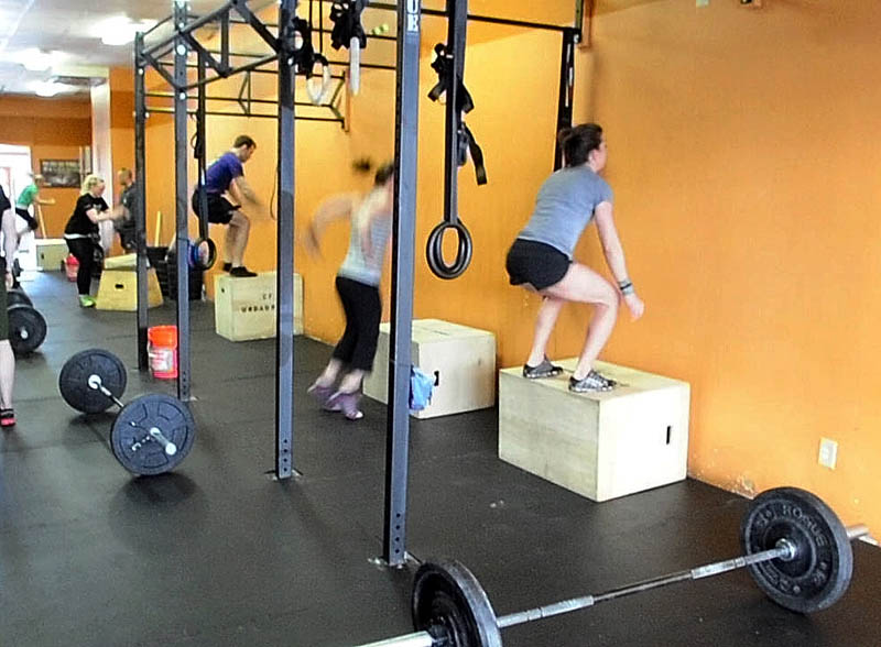 JUMP START: Crossfitters do box jumps at the start of the Klepto Hero WOD on Saturday monring at CrossFit Undaunted in Augusta. Staff photo by Joe PhelanCrossf 2013 at CrossFit Undaunted in A