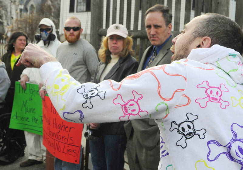 Mike Reynolds, of Lewiston, speaks during a protest on Friday in the middle of Dummers Lane in Hallowell.