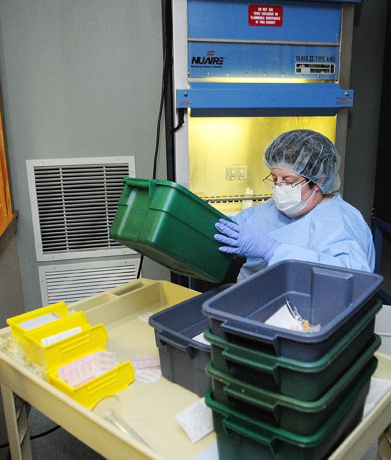 Pharmacy technician Suzanne Goddard prepares medicines in the sterile room on April 12, at Kennebec Pharmacy & Home Care in Augusta.