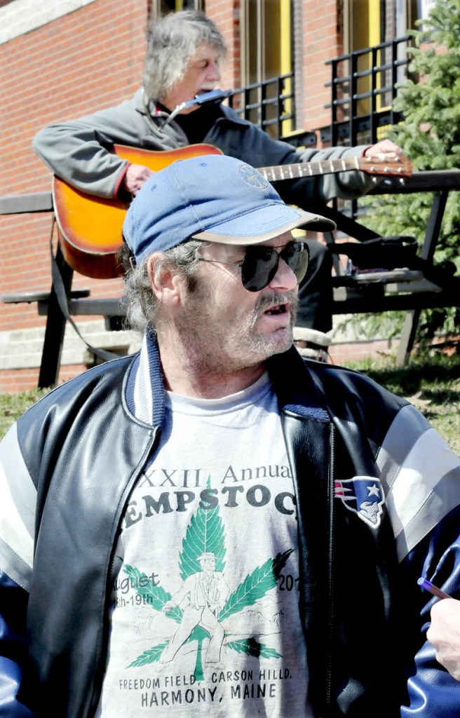 Marijuana advocates Charles Hutchins Sr., front, and John White attended a Patriots Day "smoke in" for marijuana legalization, outside the Somerset County courthouse in Skowhegan on Monday.