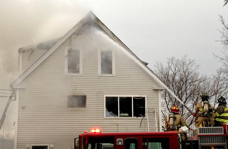 Fire companies fight a blaze at a three-unit apartment building at 10 Maple St. in Fairfield Tuesday evening.
