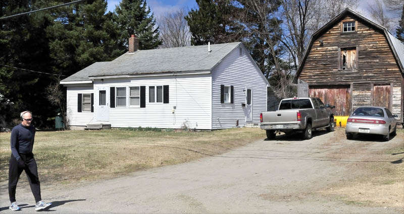 A pedestrian passes 202 Maple Ave. in Farmington, where police are investigating after finding two people deceased in the home early Monday morning. Farmington police were called to investigate a possible suicidal person on Maple Avenue, where the unidentified bodies were discovered.