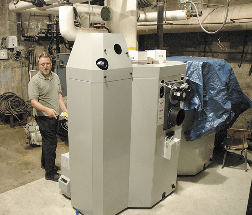 School Administrative District 74 Superintendent Ken Coville shows off a wood-pellet boiler at Garret Schenck School in Anson.