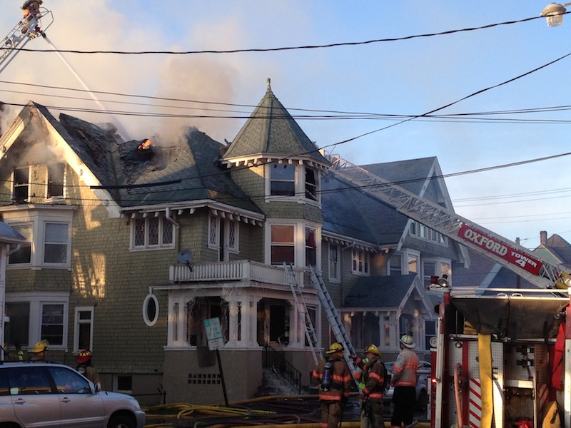 Firefighters douse a home that is on fire in Lewiston on Monday, April 29, 2013. A fire erupted in a densely populated neighborhood late in the afternoon Monday.