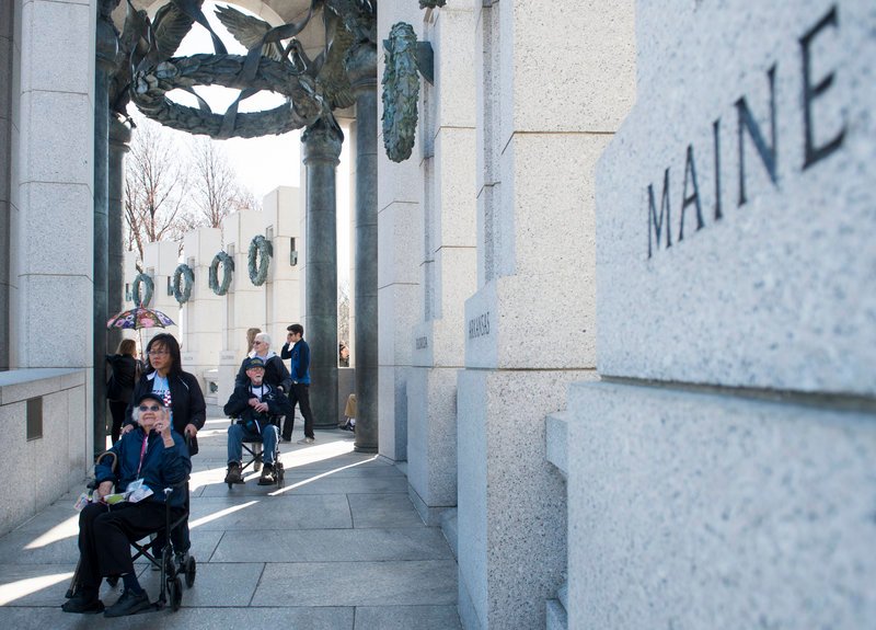Veteran Dorothea Washburn, of Harrison, points to the Maine pillar Sunday as the Honor Flight New England tour arrives at the World War II Memorial in Washington. Washburn served as a Navy storekeeper 1st Class at the Brooklyn Navy Yard.