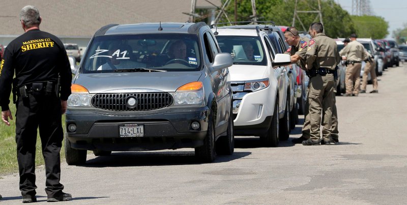 Displaced residents wait at a checkpoint Saturday as they wait to visit their homes.
