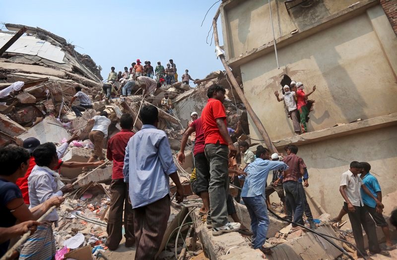 Bangladeshi rescuers work Friday at the site of a building that collapsed Wednesday in Savar, near Dhaka, Bangladesh.