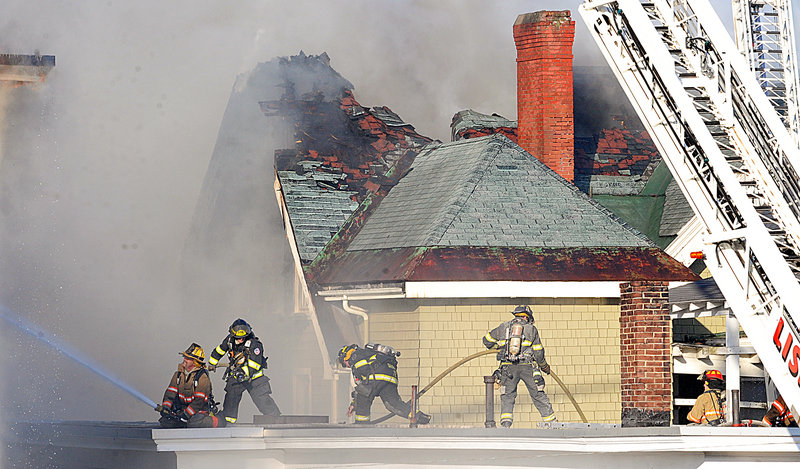 Firefighters from multiple departments battle the three-alarm fire in Lewiston. It took several hours to bring the blaze under control.