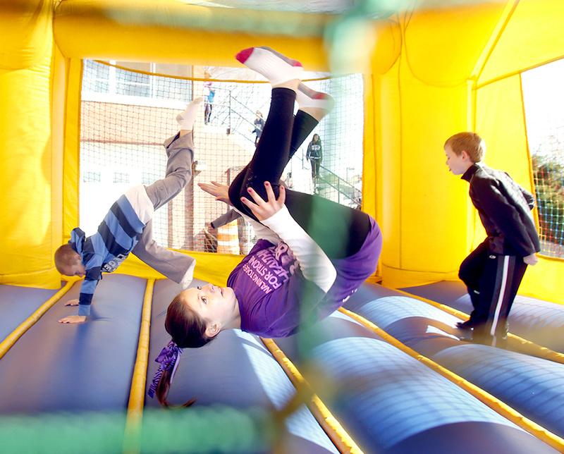 Abigail Howard,10, of Portland does a flip in a bounce house during the March of Dimes March for Babies event in Portland.
