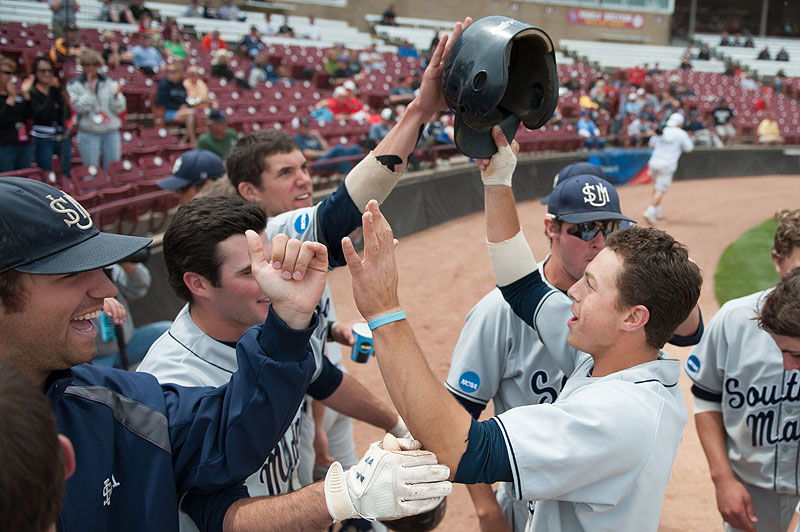 John Carey is welcomed back to the dugout after hitting a tiebreaking home run in the sixth inning. Carey was 3 for 5 with two RBI in a 7-2 victory over Webster, helping USM avoid elimination from the Division III World Series.