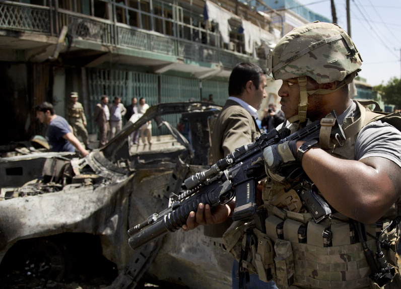 A U.S. soldier arrives to the scene where a suicide car bomber attacked a NATO convoy in Kabul, Afghanistan on Thursday.