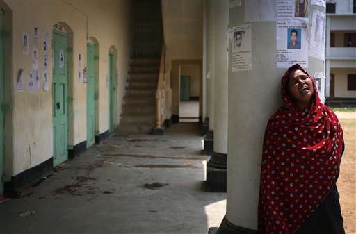 A woman grieves after finding her sister's body at a school turned makeshift morgue where family members come to identify and claim bodies found in the garment factory building collapse in Savar, Bangladesh.