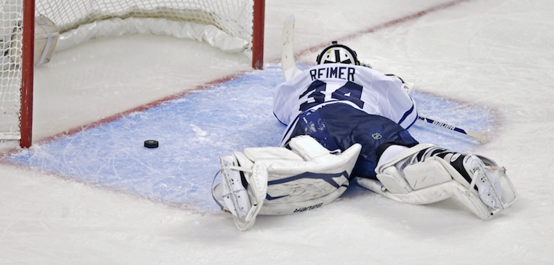 Toronto Maple Leafs goalie James Reimer lays on the ice after getting beat on the game winning goal by Boston Bruins center Patrice Bergeron during overtime in Game 7 of their NHL hockey Stanley Cup playoff series in Boston, Monday, May 13, 2013. The Bruins won 5-4. (AP Photo/Charles Krupa)