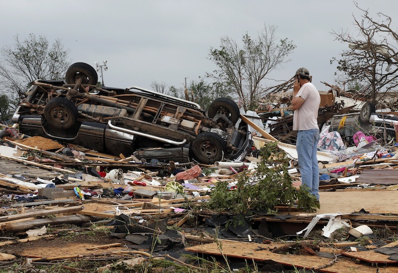 John Warner surveys the damage near a friend's mobile home in the Steelman Estates Mobile Home Park, destroyed in Sunday's tornado, near Shawnee, Okla., Monday, May 20, 2013. (AP Photo Sue Ogrocki)
