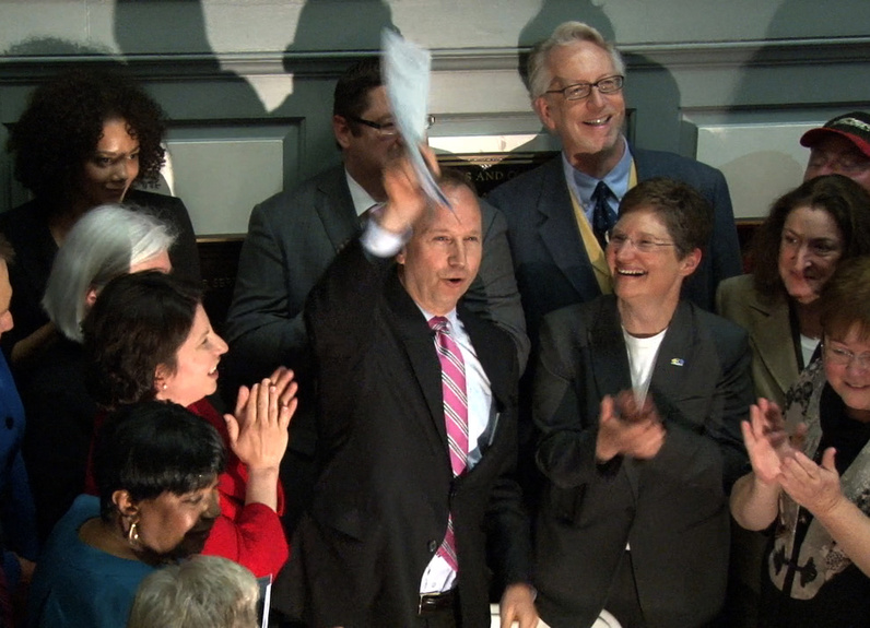 Delaware Gov. Jack Markell signs the marriage equality bill on the steps of Legislative Hall in Dover, Del., on Tuesday after it was approved by the Delaware Senate earlier that afternoon.