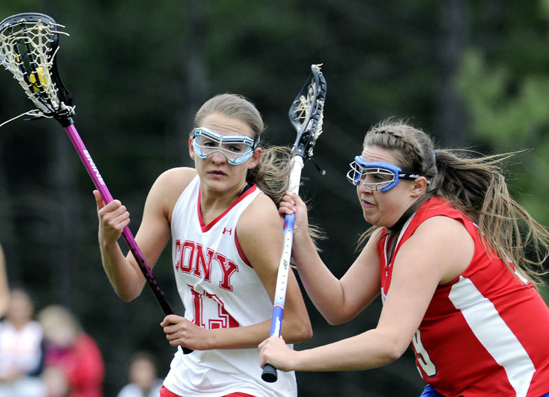 TOUGH D: Cony High School's Hayley Quirion, left, is checked by Messalonskee High School's Abby Roberts on Tuesday in Augusta. The Eagles beat the Rams 11-4.