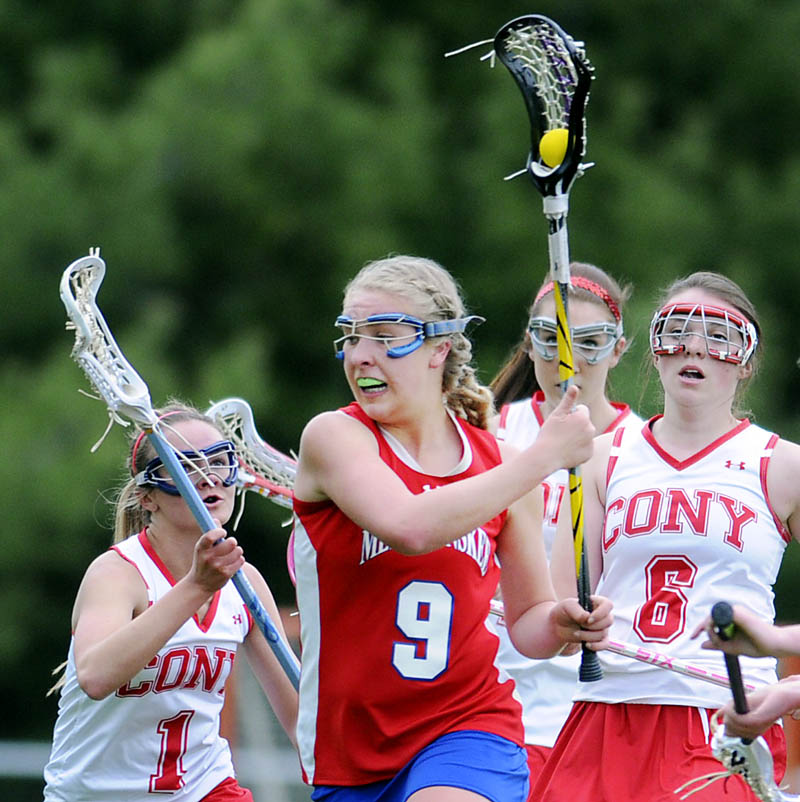 KEEP AWAY: Messalonskee High School's Mikayla Turner runs around Cony High School defenders on Tuesday in Augusta. The Eagles beat the Rams 11-4.